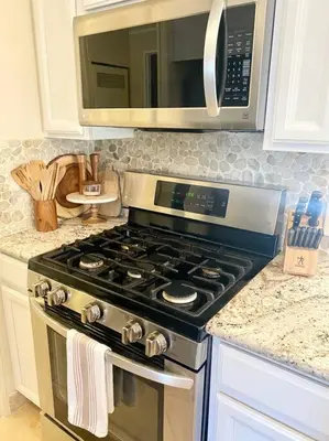 a kitchen with a stove and a microwave at B-B Ranch Cottage~Heart of Gold Country~*HOT TUB* in Pilot Hill