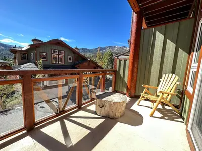 a balcony with a chair and a table and a chair at Juniper Crest #2 townhouse in Mammoth Lakes