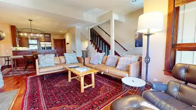 a living room with leather couches and a table at Juniper Crest #2 townhouse in Mammoth Lakes