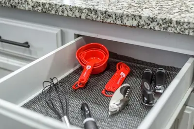 a drawer withrenches and other kitchen utensils in it at 3BR Cozy Home~ Stylish & New ~ UC Merced ~ en route Yosemite! in Merced