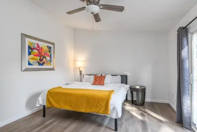 a white bedroom with a bed and a ceiling fan at 3BR Cozy Home~ Stylish & New ~ UC Merced ~ en route Yosemite! in Merced