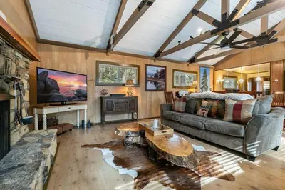 a living room with a couch and a table at Classic 3BD Tahoe Cabin with Hot Tub in Carnelian Bay