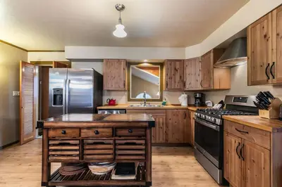 a kitchen with wooden cabinets and a stainless steel refrigerator at Classic 3BD Tahoe Cabin with Hot Tub in Carnelian Bay