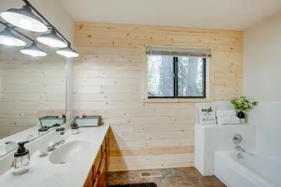 a bathroom with a white sink and a tub at Arnold Cabin Near Calaveras Big Trees State Park! in Arnold
