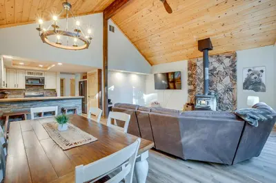 a kitchen and dining room with a table and a couch at Arnold Cabin Near Calaveras Big Trees State Park! in Arnold