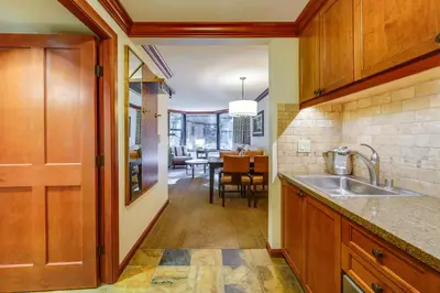 a kitchen with a sink and a dining room at Breathtaking Olympic Valley Gem Walk to Chairlift in Olympic Valley