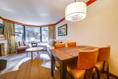 a living room with a dining room table and a couch at Breathtaking Olympic Valley Gem Walk to Chairlift in Olympic Valley