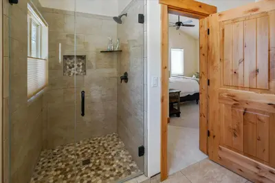 a bathroom with a shower with a glass door at Agate Bay Gem by Tahoe Getaways - Charming Getaway with Cozy Fireplace Near Hiking and Biking Trails in Tahoe Vista
