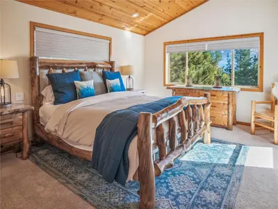 a bedroom with a large bed and a window at Bear Peak Cabin by Tahoe Getaways - Tahoe Donner Rental with Private Hot Tub and Bonus Room in Truckee