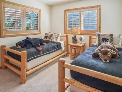 a bedroom with two beds with a stuffed animal on it at Bear Peak Cabin by Tahoe Getaways - Tahoe Donner Rental with Private Hot Tub and Bonus Room in Truckee