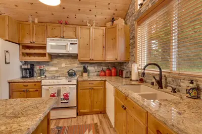 a kitchen with wooden cabinets and a counter top at Bear's Lair by Tahoe Getaways - 3 BR in Tahoe Donner with Hot Tub & Bonus Room! in Truckee