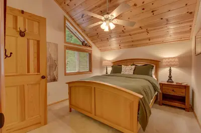 a bedroom with a bed and a ceiling fan at Bear's Lair by Tahoe Getaways - 3 BR in Tahoe Donner with Hot Tub & Bonus Room! in Truckee