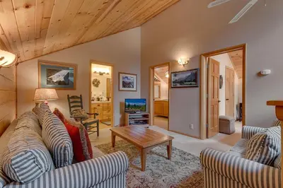 a living room with two couches and a table at Bear's Lair by Tahoe Getaways - 3 BR in Tahoe Donner with Hot Tub & Bonus Room! in Truckee