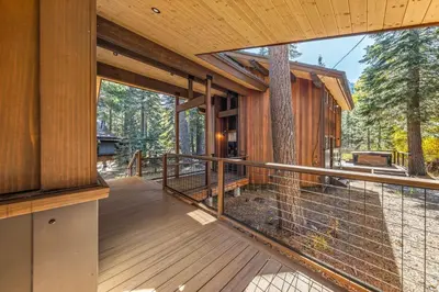 a screened in porch of a house with a bird cage at Birchwood Retreat by Tahoe Getaways - Newly Remodeled Pet Friendly Home in Alpine Meadows with Wood Fireplace, Hot Tub & Ski Shuttle! in Alpine Meadows