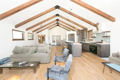 a living room with a couch and a table at Beaver Lake View by Tahoe Getaways - Pet Friendly 3 BR with Hot Tub, Wood Fireplace & Close to Skiing in Kings Beach