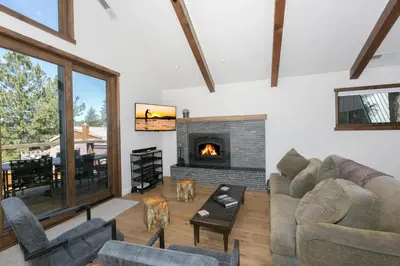 a living room with a couch and a fireplace at Beaver Lake View by Tahoe Getaways - Pet Friendly 3 BR with Hot Tub, Wood Fireplace & Close to Skiing in Kings Beach