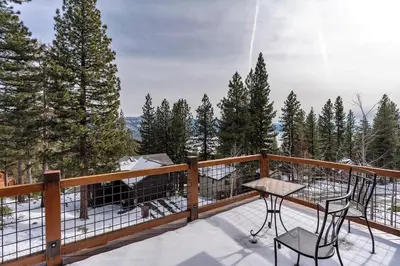 a balcony with two chairs and a table on a deck at Mountain Zen Tahoe Luxury Property Incline Village Lakeview in Incline Village