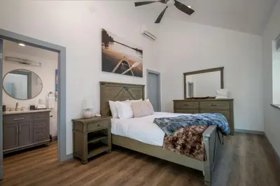 a bedroom with a bed and a bathroom with a sink at Entire Villa in Sierra Mountains in Alta