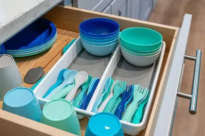 a drawer filled with blue and white bowls and utensils at Entire Villa in Sierra Mountains in Alta