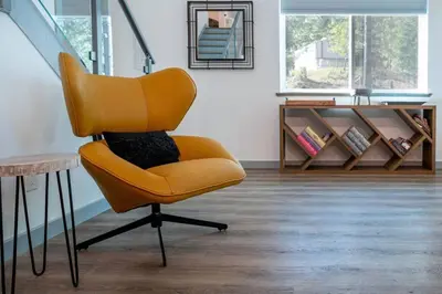 a yellow chair sitting in a room with a table at Entire Villa in Sierra Mountains in Alta