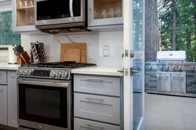 a kitchen with a stove and a microwave at Luxury Villa in Sierra Mountains in Alta