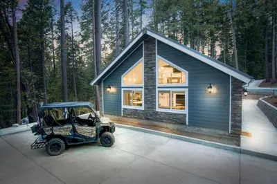 a small house with a golf cart parked in front of it at Luxury Villa in Sierra Mountains in Alta