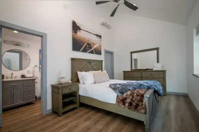 a bedroom with a bed and a sink and a mirror at Newly Built Luxury Villa in the Sierra Mountains in Alta