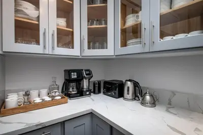 a kitchen counter with a microwave and a coffee maker at Newly Built Luxury Villa in the Sierra Mountains in Alta