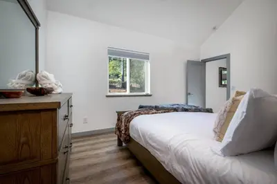 a bedroom with a bed and a dresser and a window at Newly Built Luxury Villa in the Sierra Mountains in Alta