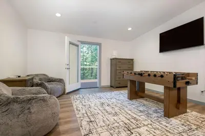 a living room with a ping pong table and a tv at Newly Built Luxury Villa in the Sierra Mountains in Alta