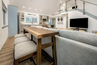 a kitchen and living room with a table and a couch at Newly Built Luxury Villa in the Sierra Mountains in Alta
