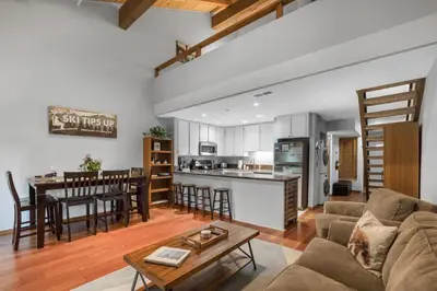 a living room and kitchen with a couch and a table at Alpine Escape: Tahoe Oasis Steps from Lake in Carnelian Bay