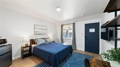 a bedroom with a bed with a blue blanket at Adventure Lodge in South Lake Tahoe