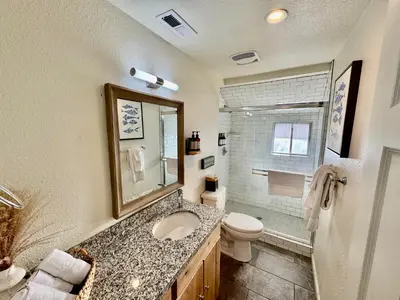 a bathroom with a sink and a toilet and a shower at Adventure Lodge in South Lake Tahoe