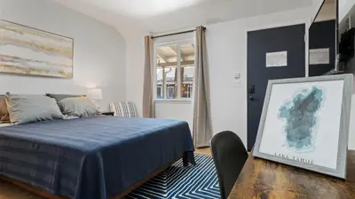 a bedroom with a blue bed and a chair at Adventure Lodge in South Lake Tahoe