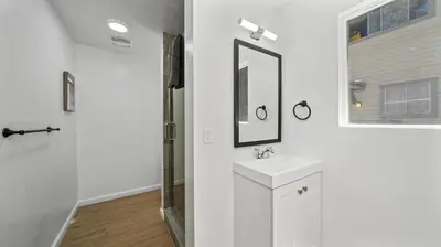 a white bathroom with a sink and a mirror at Adventure Lodge in South Lake Tahoe