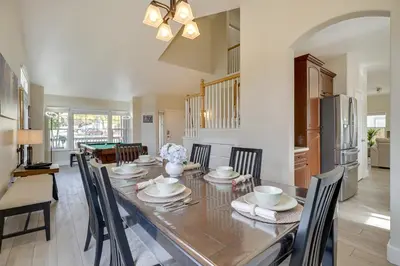 a dining room with a long table with chairs at 4 Mi to Downtown Reno Family Retreat with Fireplace in Reno