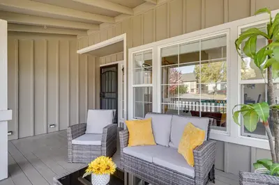a porch with wicker chairs and a table at 4 Mi to Downtown Reno Family Retreat with Fireplace in Reno
