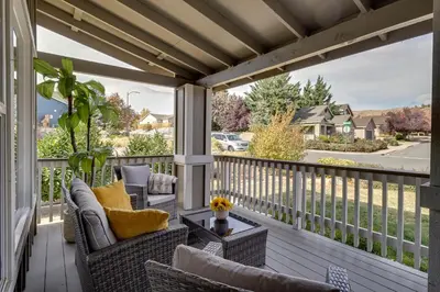 a screened porch with wicker chairs and a table at 4 Mi to Downtown Reno Family Retreat with Fireplace in Reno