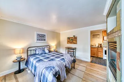 a bedroom with a bed and a fireplace at Moose and Maple Lodge in South Lake Tahoe