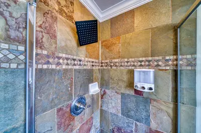 a bathroom with a shower with colorful tiles at Moose and Maple Lodge in South Lake Tahoe