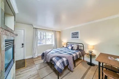 a bedroom with a bed and a tv at Moose and Maple Lodge in South Lake Tahoe