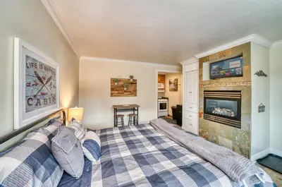 a bedroom with a bed and a fireplace at Moose and Maple Lodge in South Lake Tahoe
