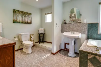 a bathroom with a toilet and a sink and a mirror at Spacious Reno Vacation Rental about 3 Mi to MidTown! in Reno