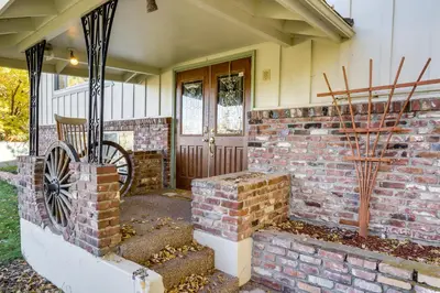 a home with a brick wall and a wooden door at Spacious Reno Vacation Rental about 3 Mi to MidTown! in Reno
