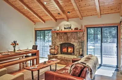 a living room with a large stone fireplace at Truckee Northstar Family Home by Jaeger Retreat in Truckee