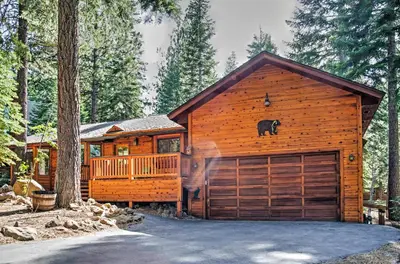 a log cabin with a black bear on the roof at Truckee Northstar Family Home by Jaeger Retreat in Truckee