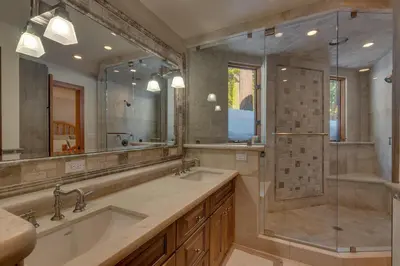 a bathroom with two sinks and a shower at Big John at Alpine Meadows by Tahoe Getaways - Mountain Views, Cozy Fireplace, Shuttle to Slopes! in Alpine Meadows