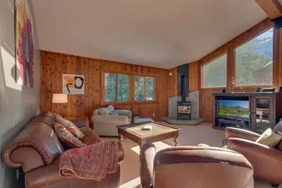a living room with leather furniture and a fireplace at Big John at Alpine Meadows by Tahoe Getaways - Mountain Views, Cozy Fireplace, Shuttle to Slopes! in Alpine Meadows