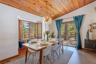 a dining room with a table and chairs at Camp Telemark by Tahoe Getaways - Pet-Friendly 3 BR in Tahoe Donner with Hot Tub & Wood Fireplace in Truckee